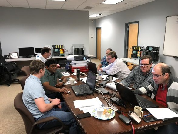 Engineers in a room discussing PCS7 training